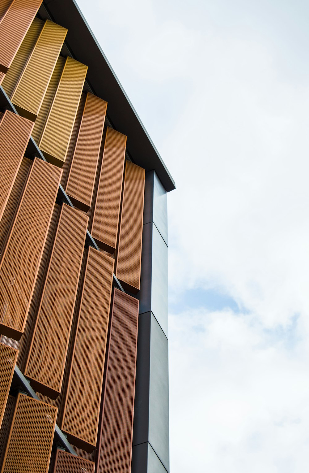 a tall brown building with lots of windows