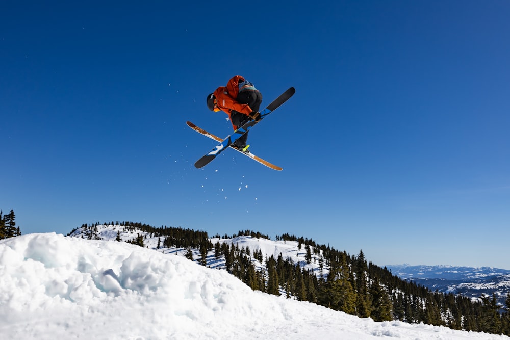 a man flying through the air while riding skis