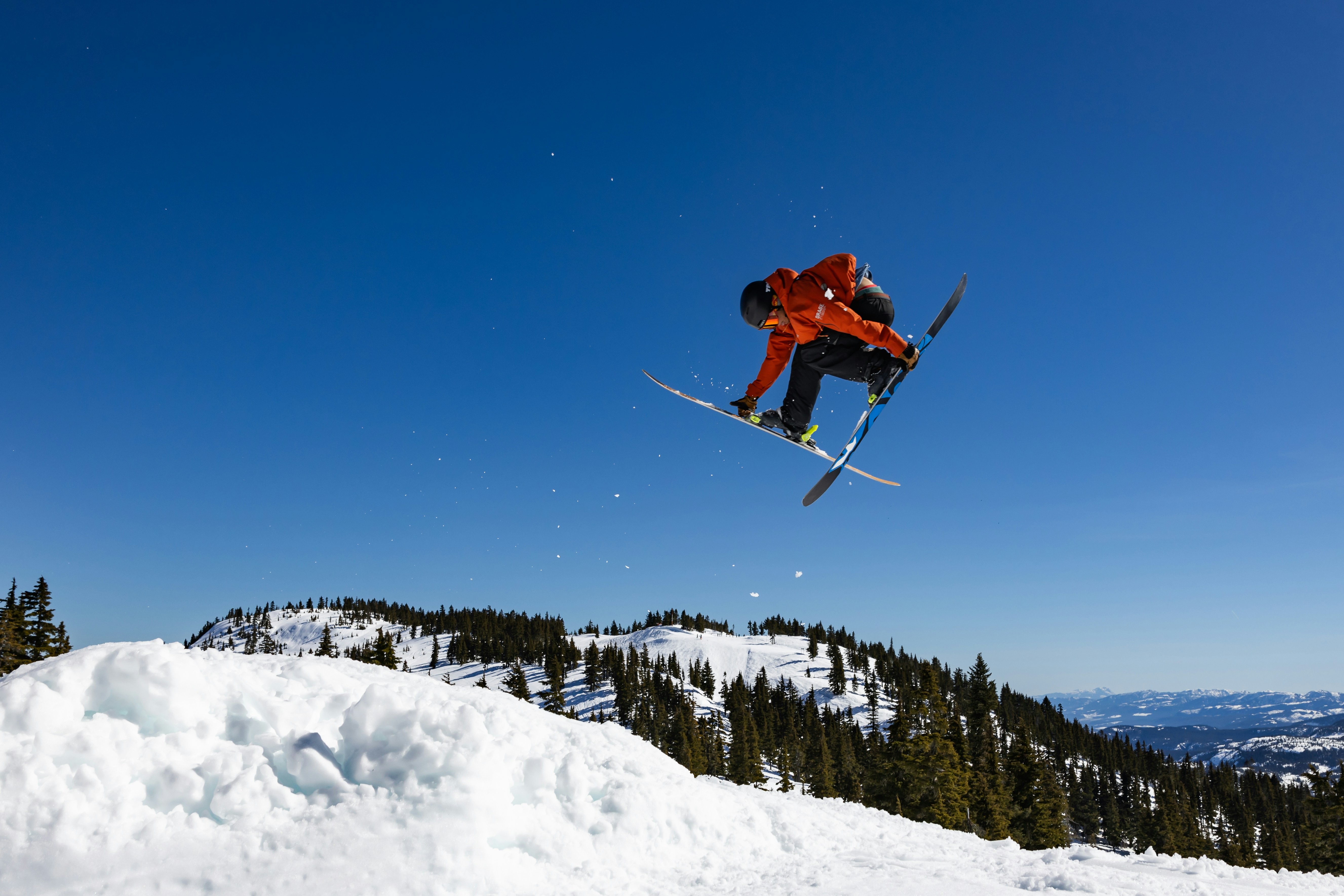 a man flying through the air while riding skis, 