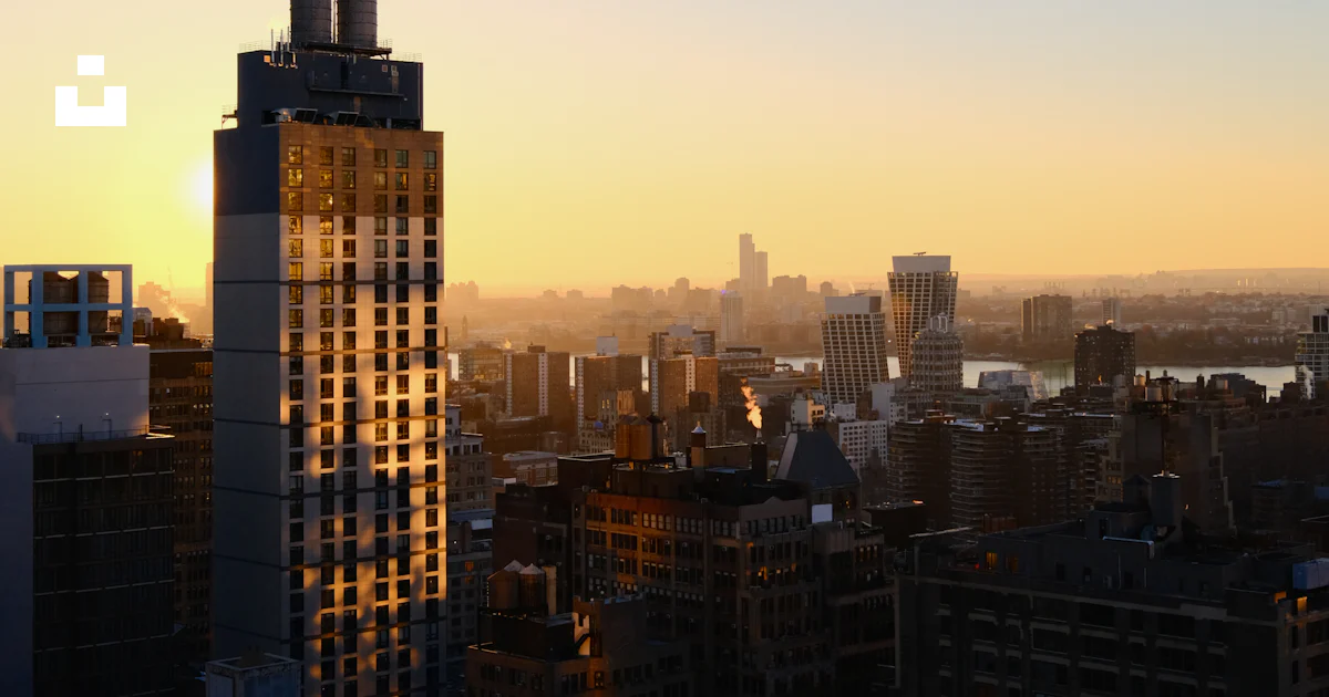 A view of a city at sunset from a high rise photo – Free Sunset Image ...
