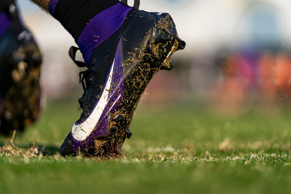 a close up of a soccer shoe on a field