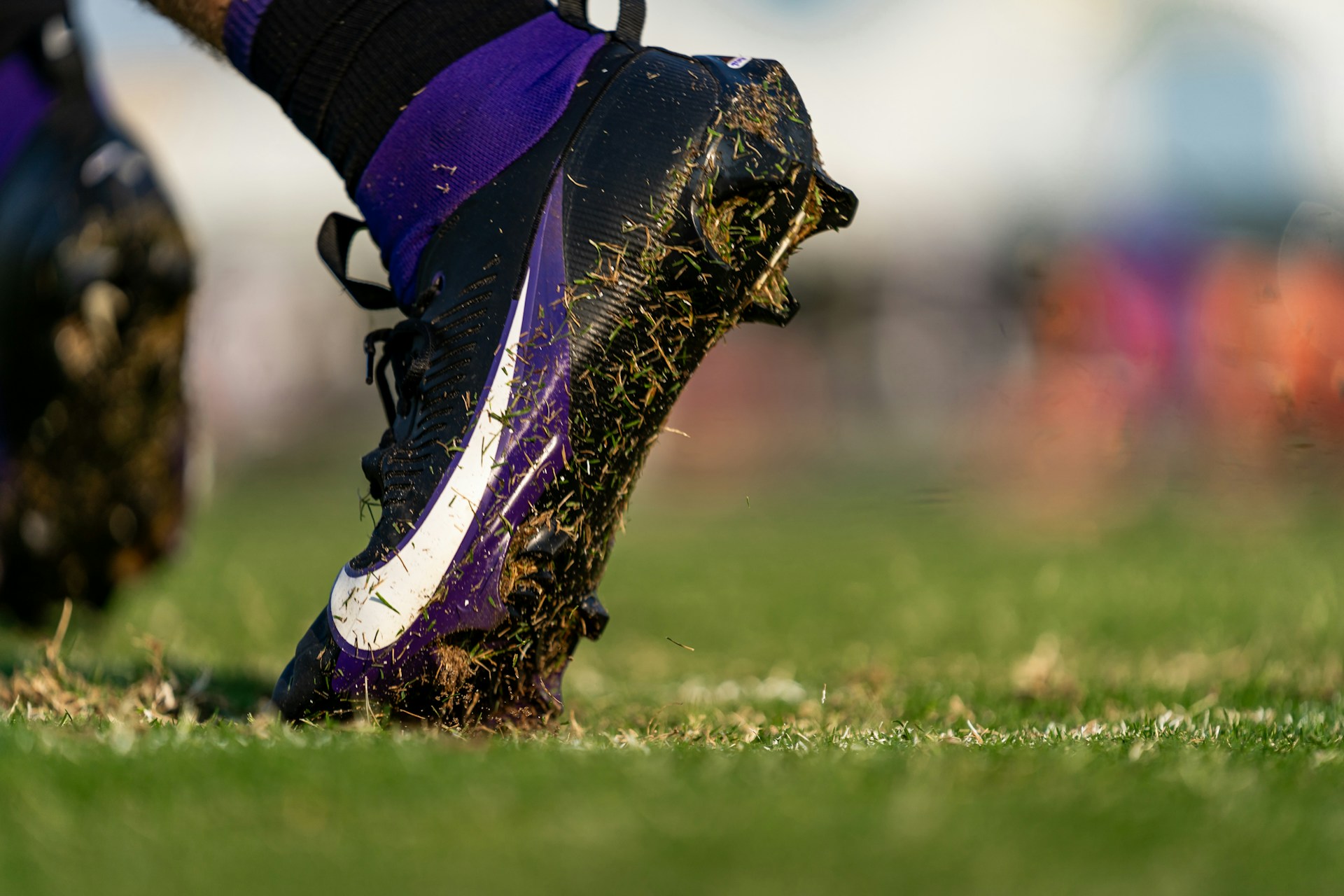 a close up of a soccer shoe on a field