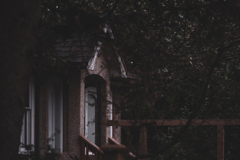 a house with a porch and a wooden fence