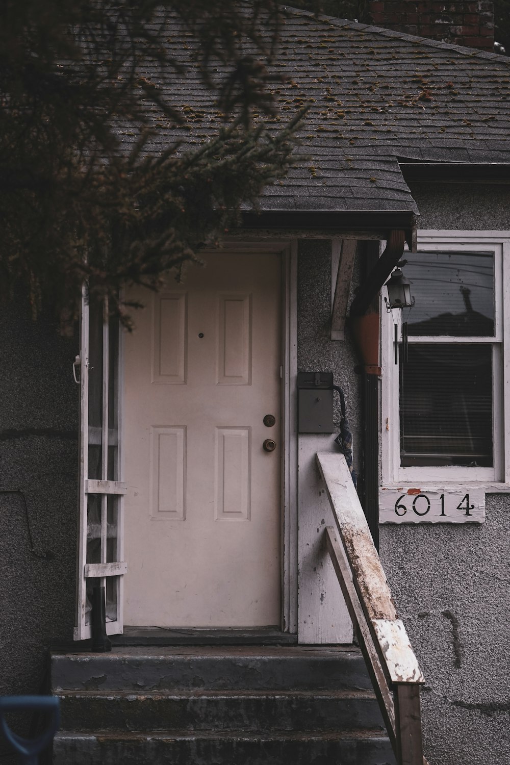 a white door and steps leading to a house