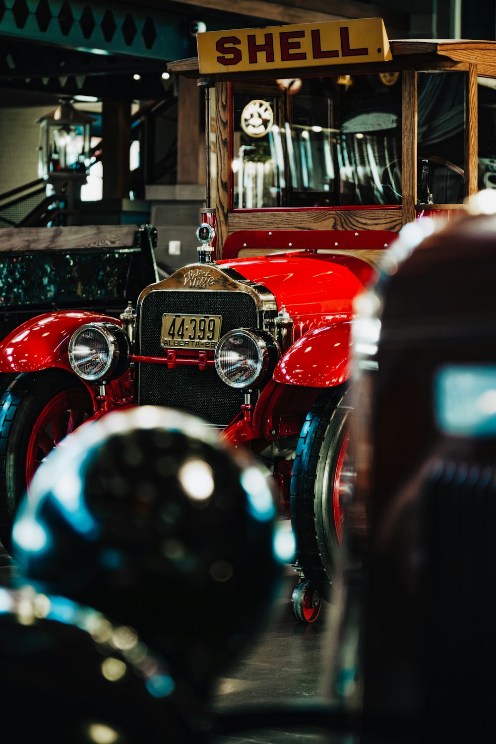 a row of old fashioned cars parked in a garage