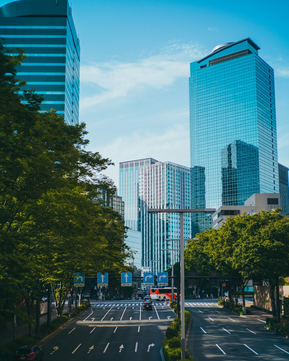 a city street with tall buildings in the background