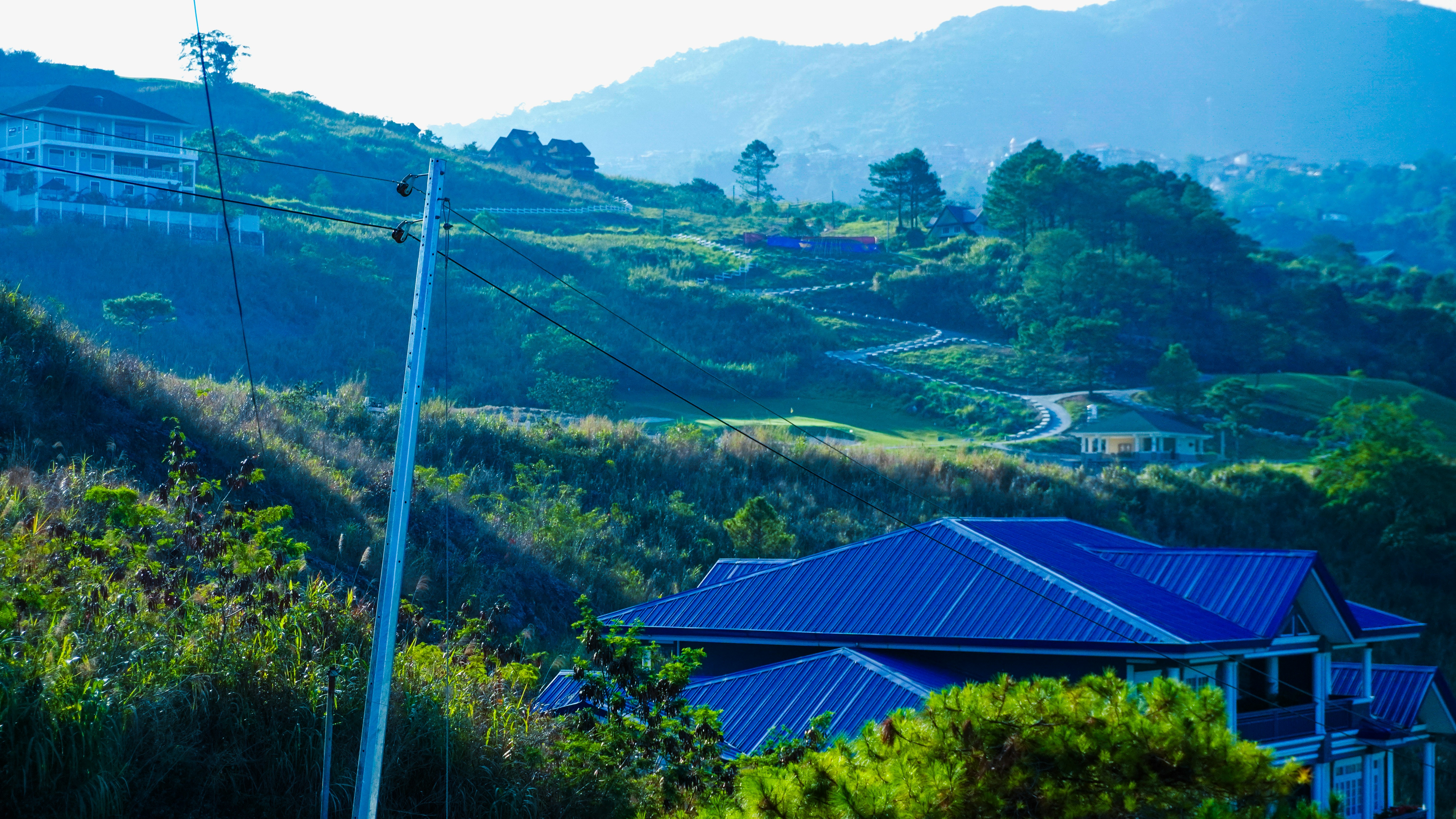 a house on a hill with a blue roof