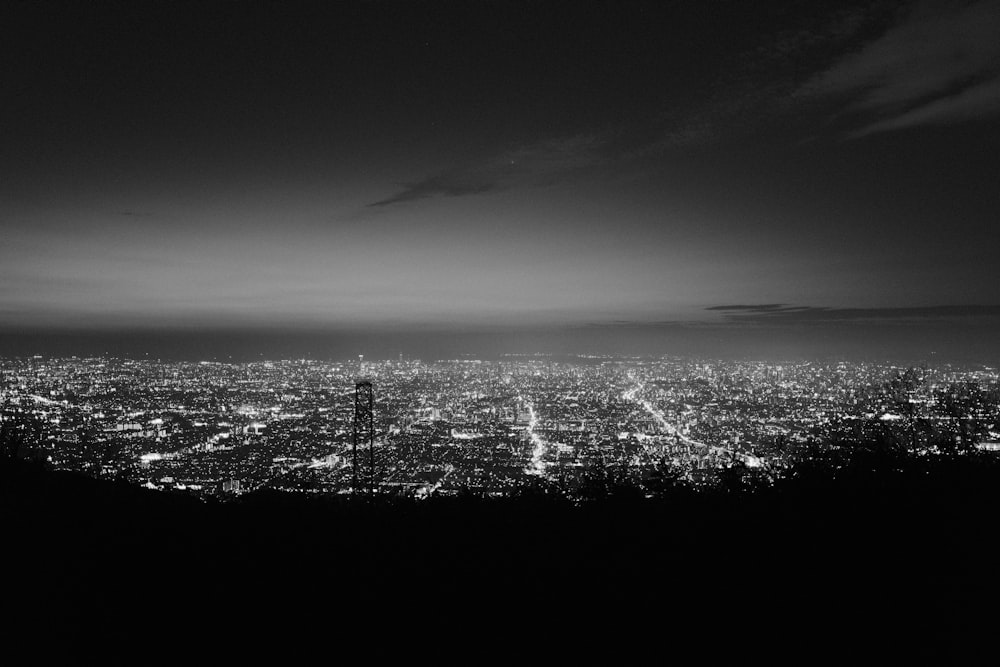 a black and white photo of a city at night