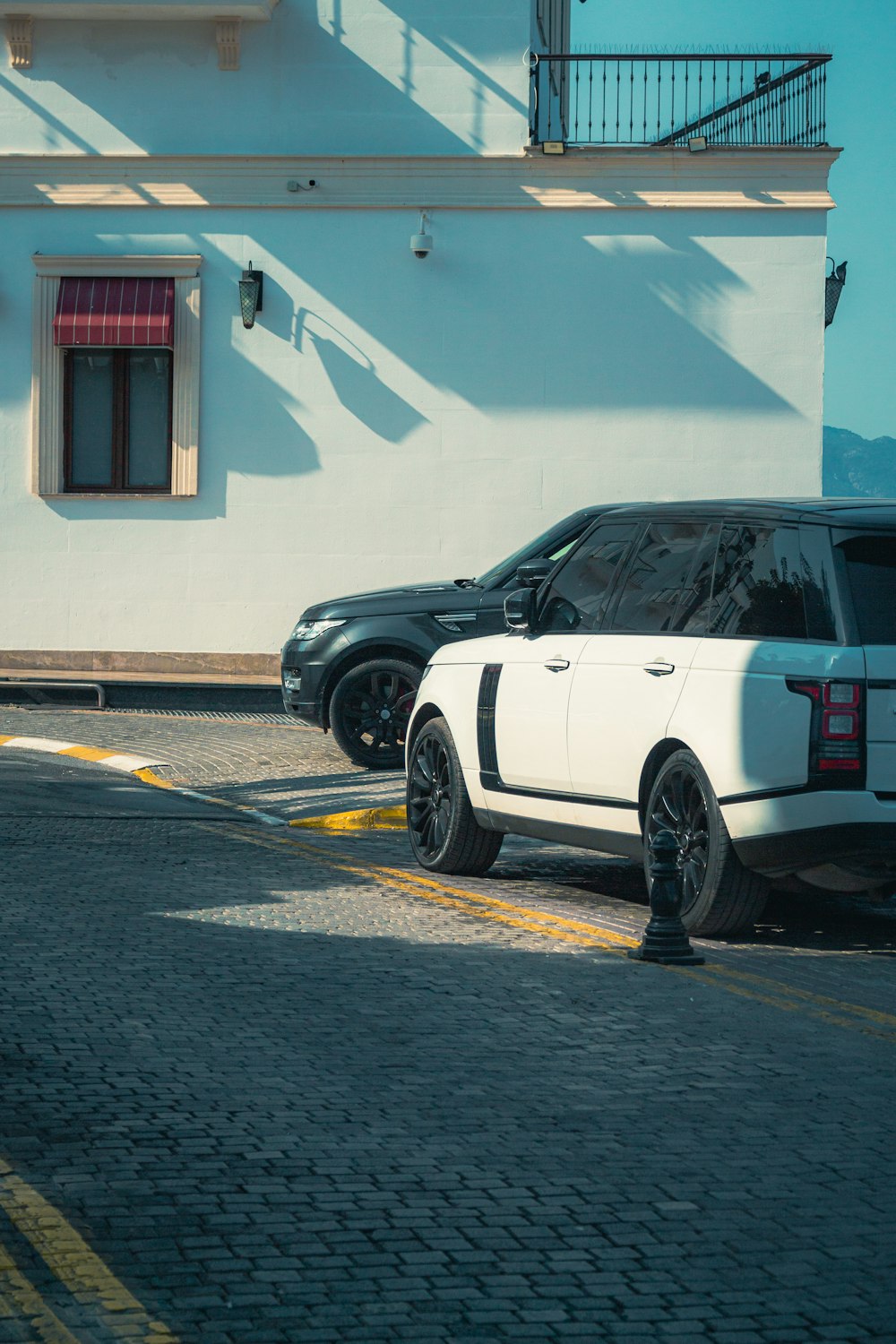 a range rover parked in front of a white building