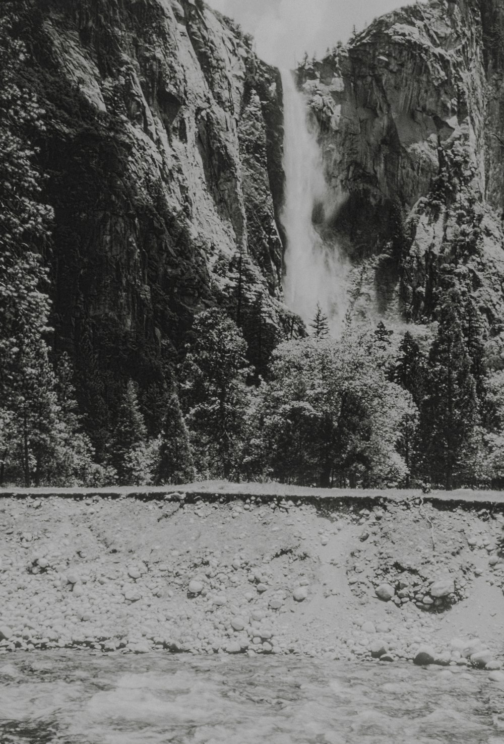 a black and white photo of a waterfall