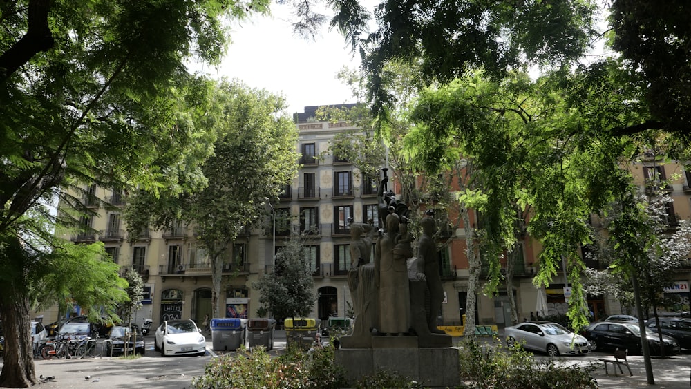 a city street with a statue in the middle of it