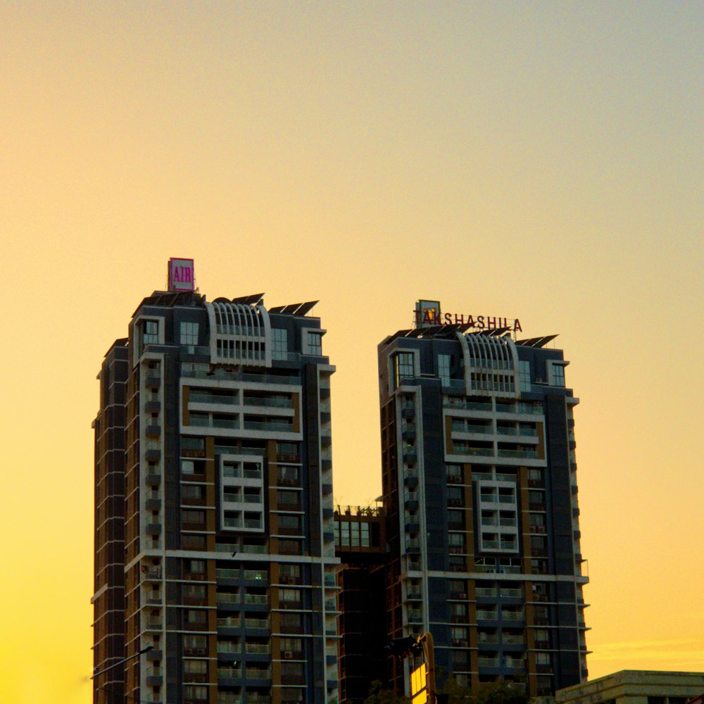 a couple of tall buildings sitting next to each other