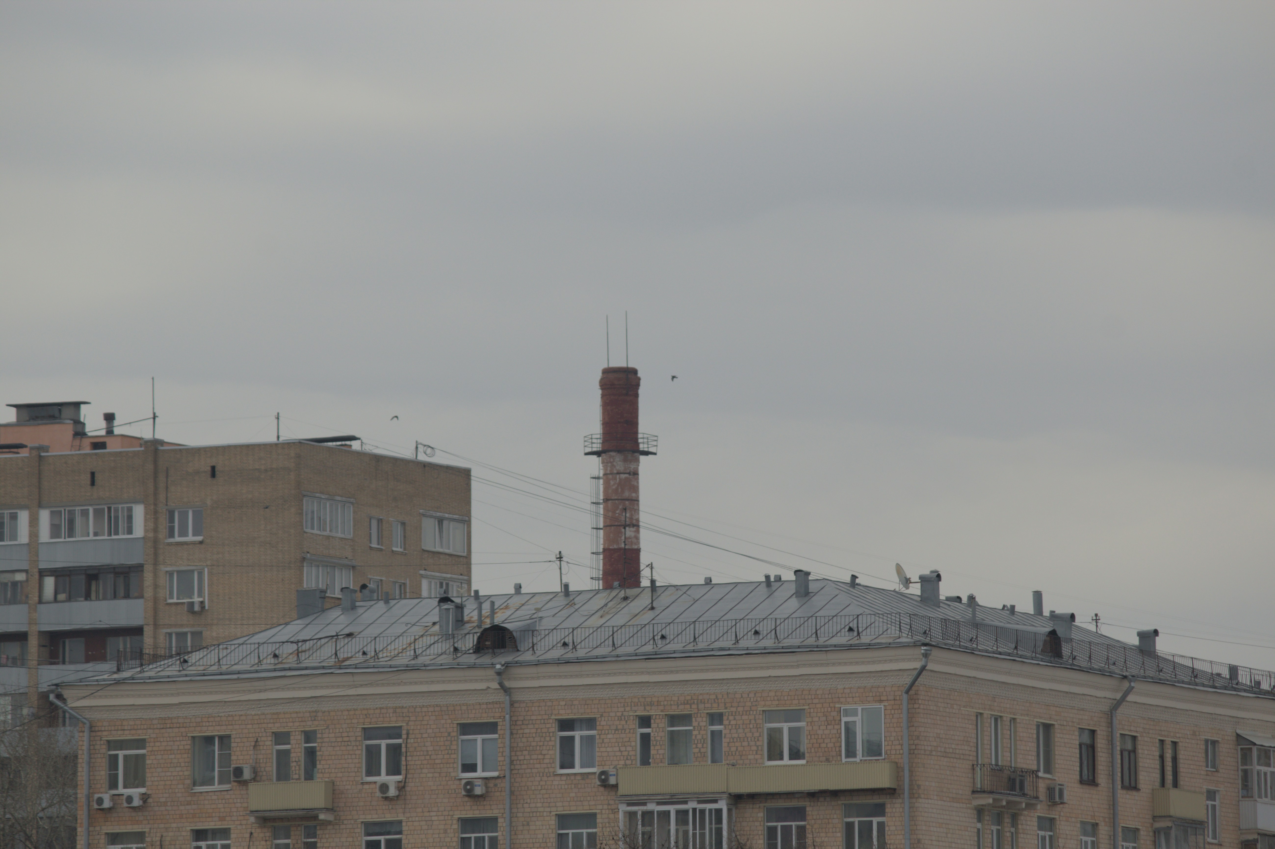 a tall brick building with a metal roof (Photo by Evgenii Dzhivelikian on Unsplash)