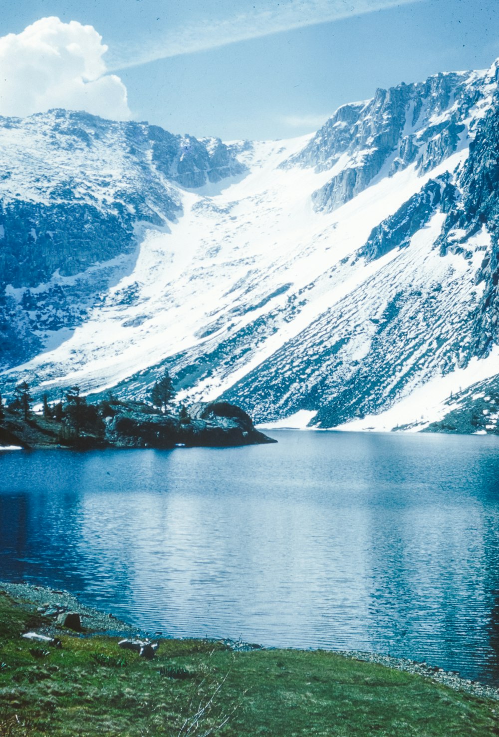 a mountain lake surrounded by snow covered mountains
