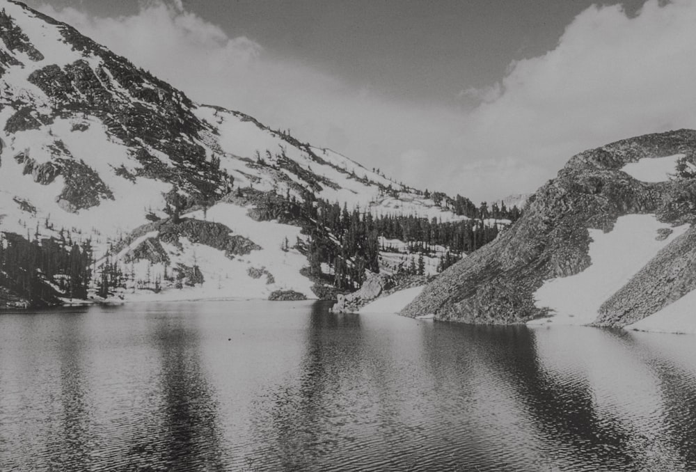 a black and white photo of a mountain lake