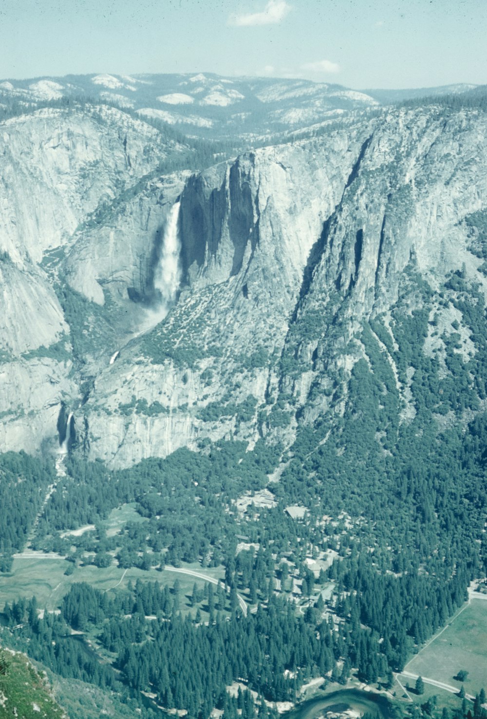 a scenic view of a valley and mountains