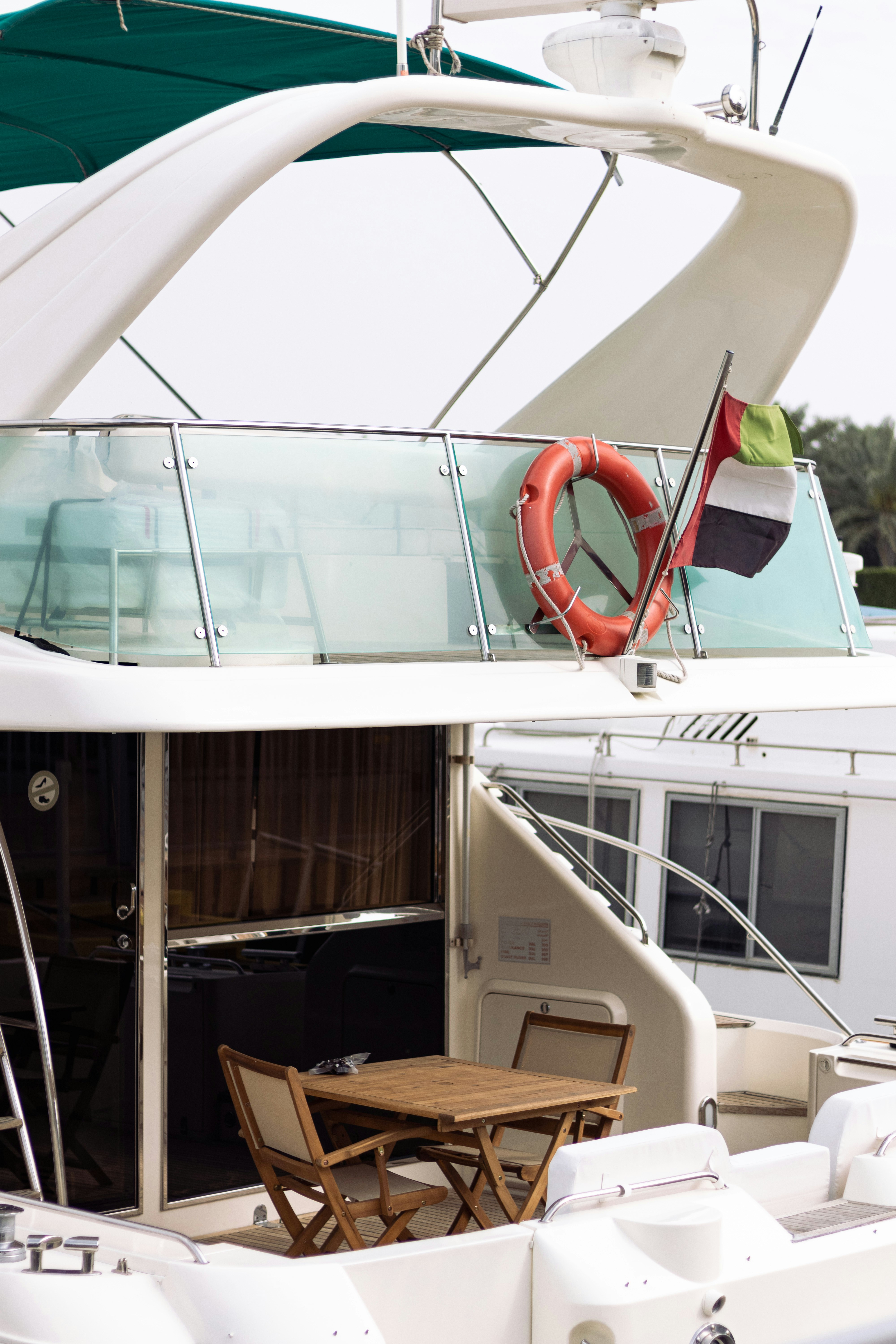 Luxury white yacht cruising Dubai Marina with skyline views and sun deck