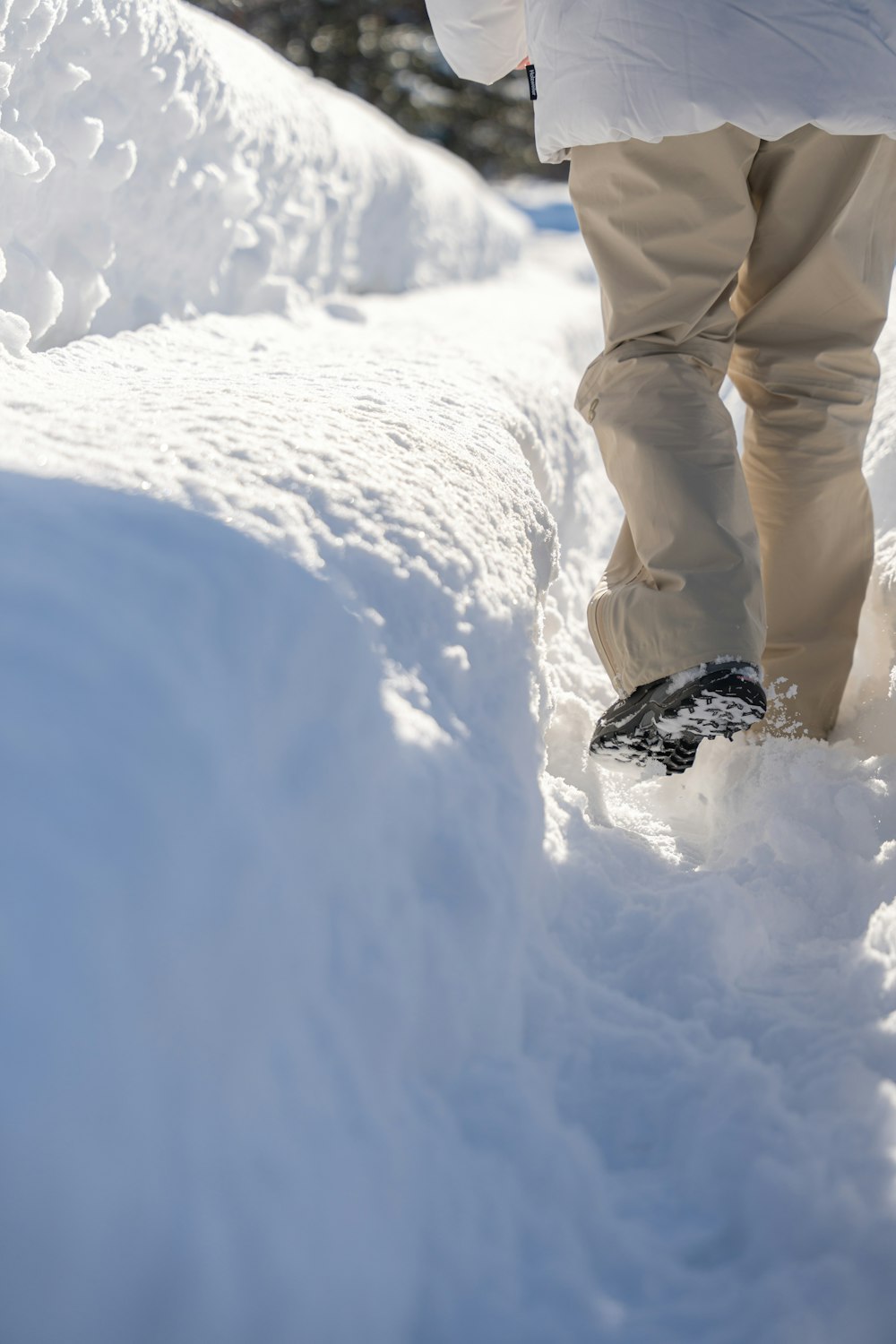 a person walking in the snow on a pair of skis