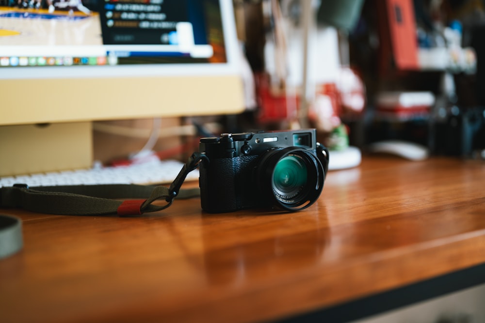 a camera sitting on top of a wooden desk