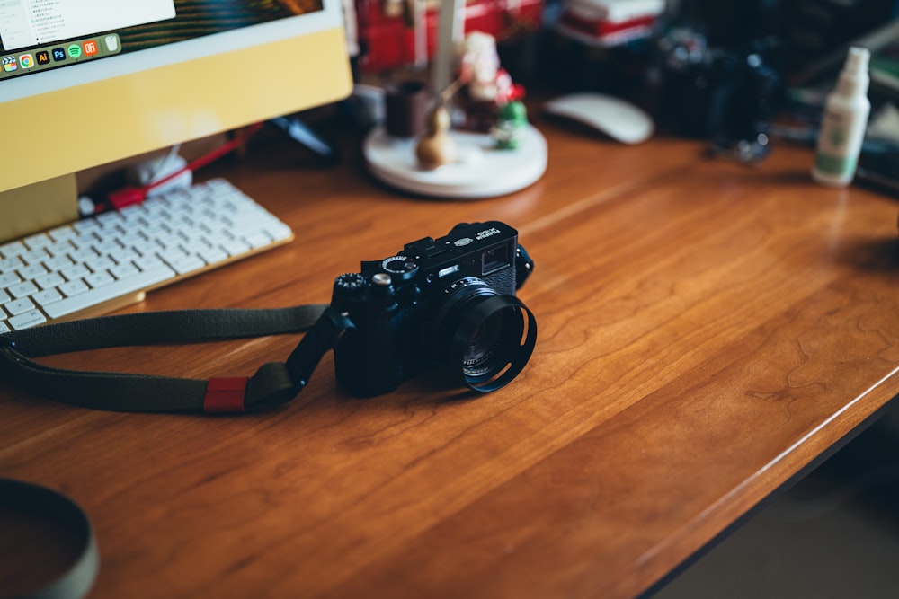 a camera sitting on a desk next to a computer