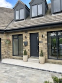 a house with two large planters in front of it