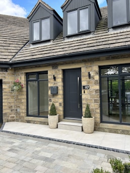 a house with two large planters in front of it
