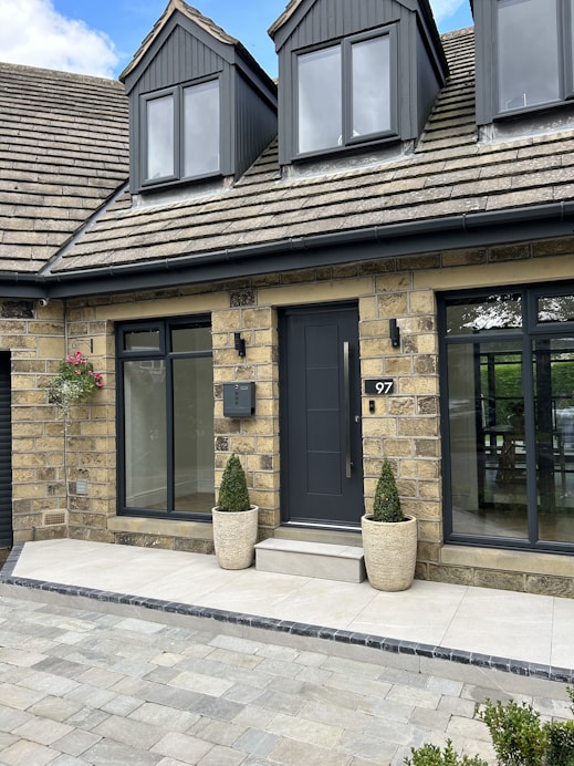 a house with two large planters in front of it