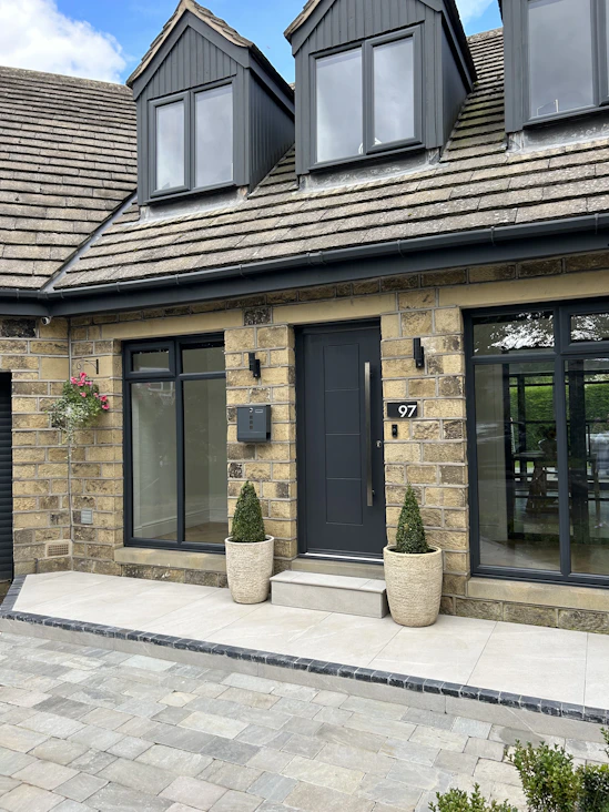 a house with two large planters in front of it
