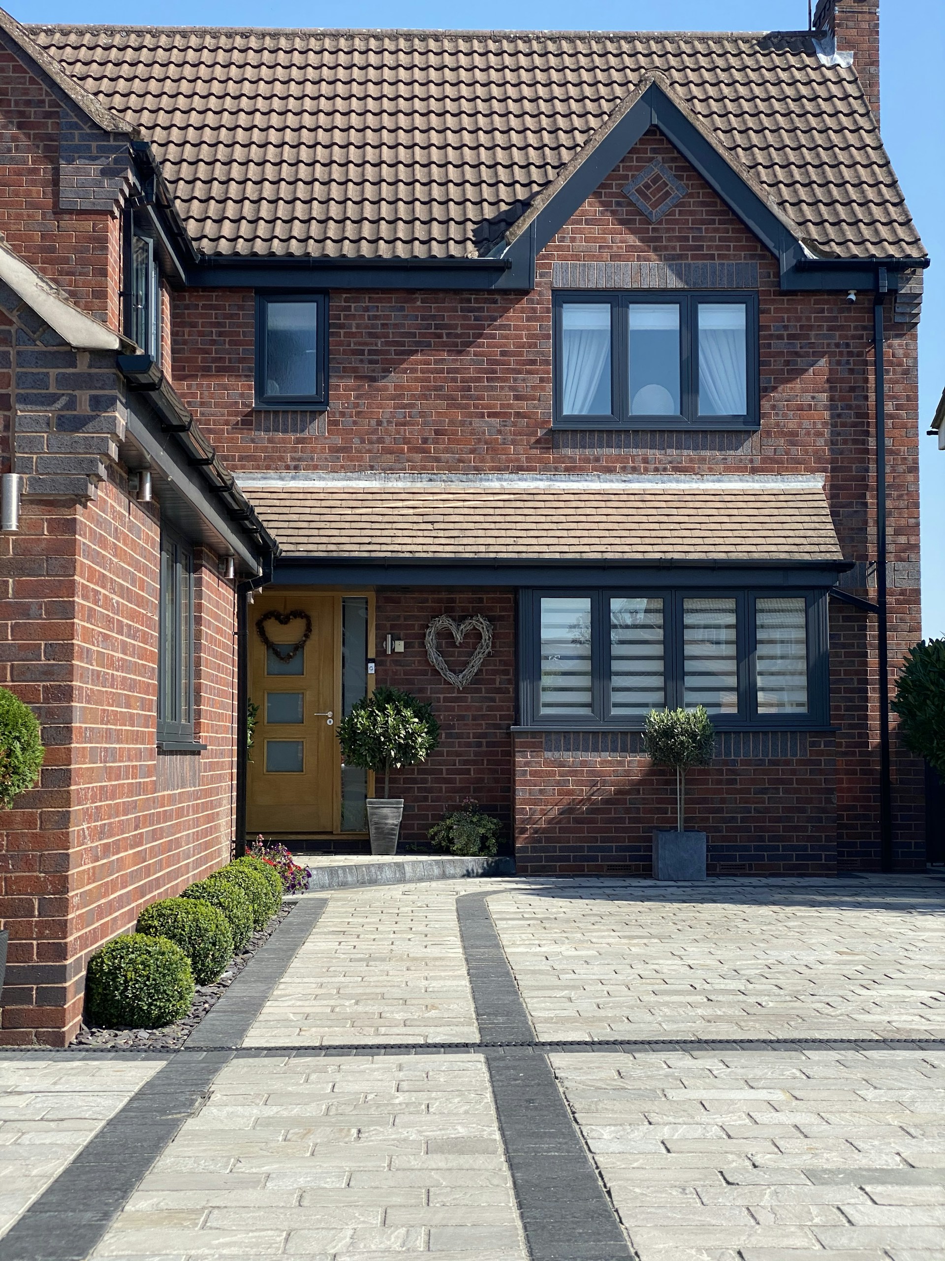 a large brick house with a yellow door