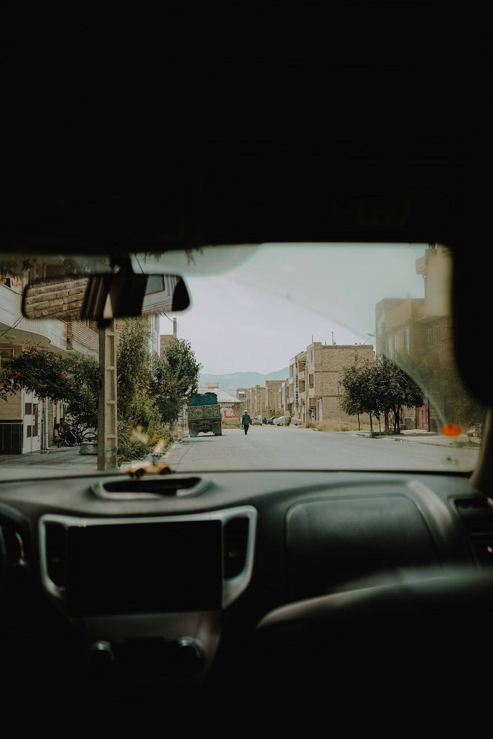 a view of a street from inside a car