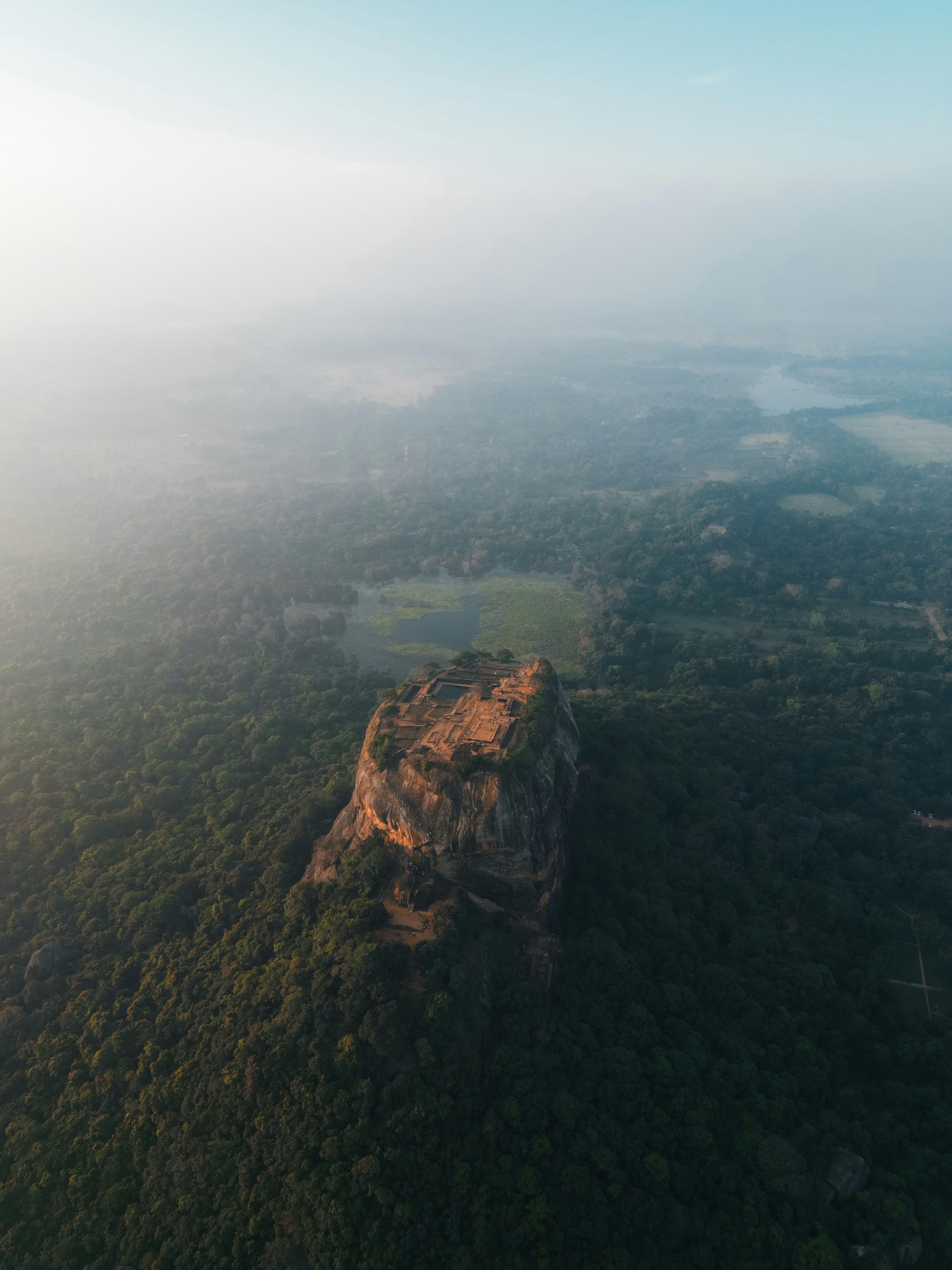 an aerial view of a mountain in the middle of a forestby sander traa