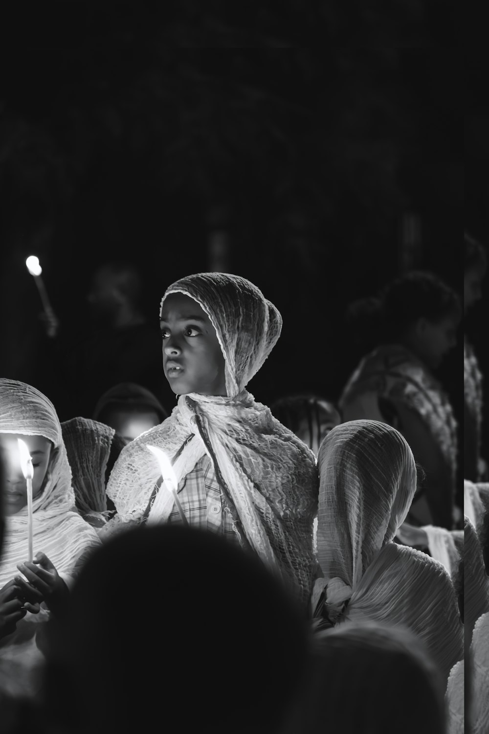 a black and white photo of a woman in a veil