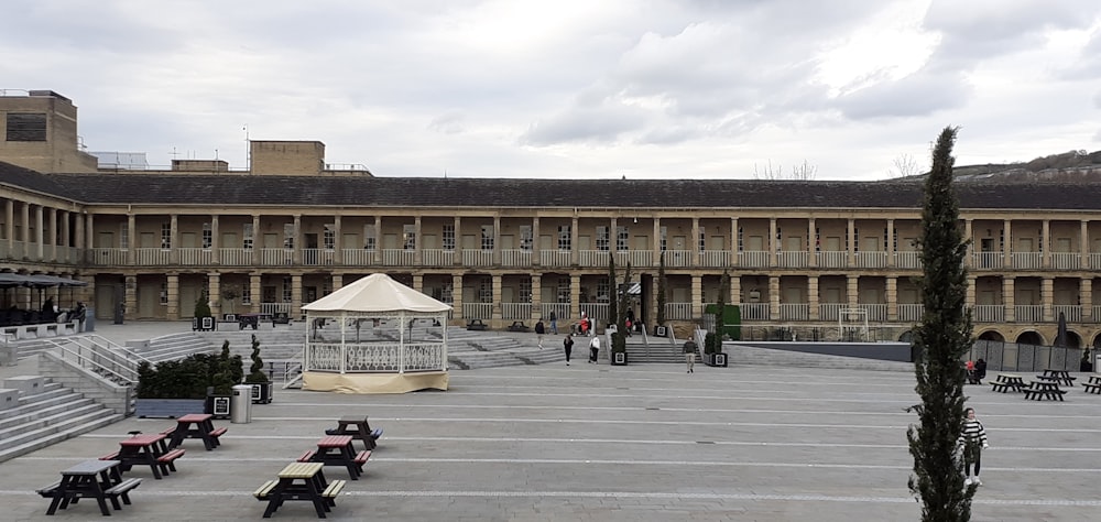 a courtyard with benches and a gazebo in the middle