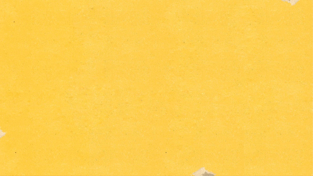 a piece of yellow paper with torn edges