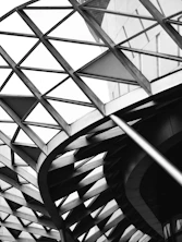 a black and white photo of a spiral staircase