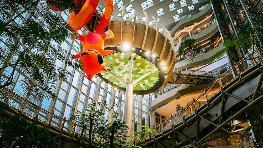 a large atrium with a sculpture of a tree inside of it