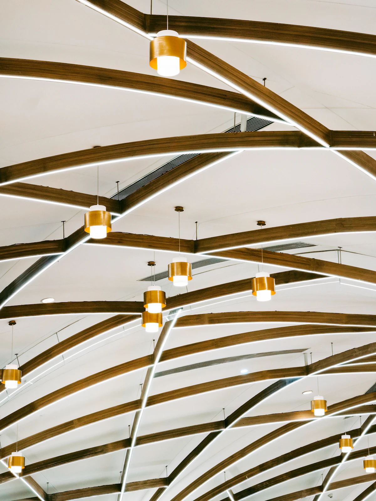 A ceiling with wooden beams and lights hanging from it