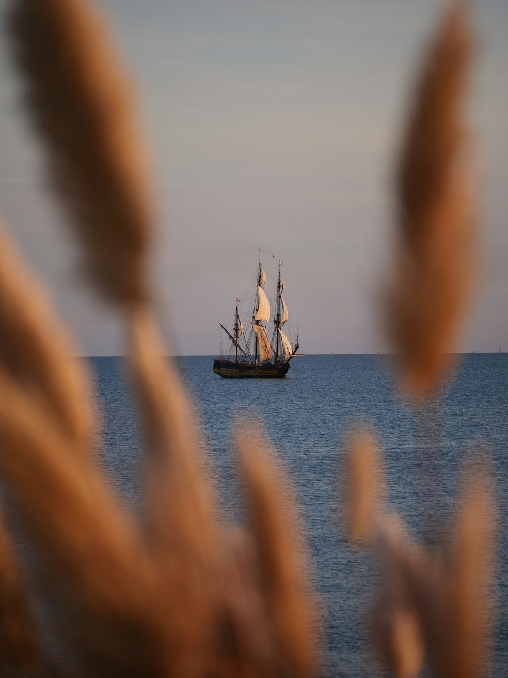 a boat sailing in the ocean on a clear day