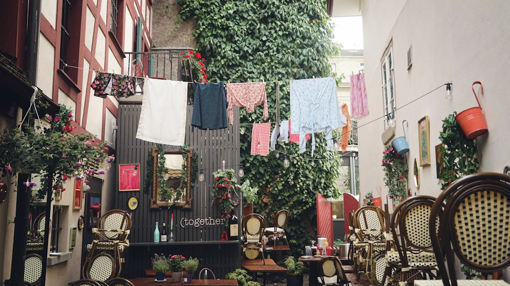 a narrow alleyway with tables and chairs