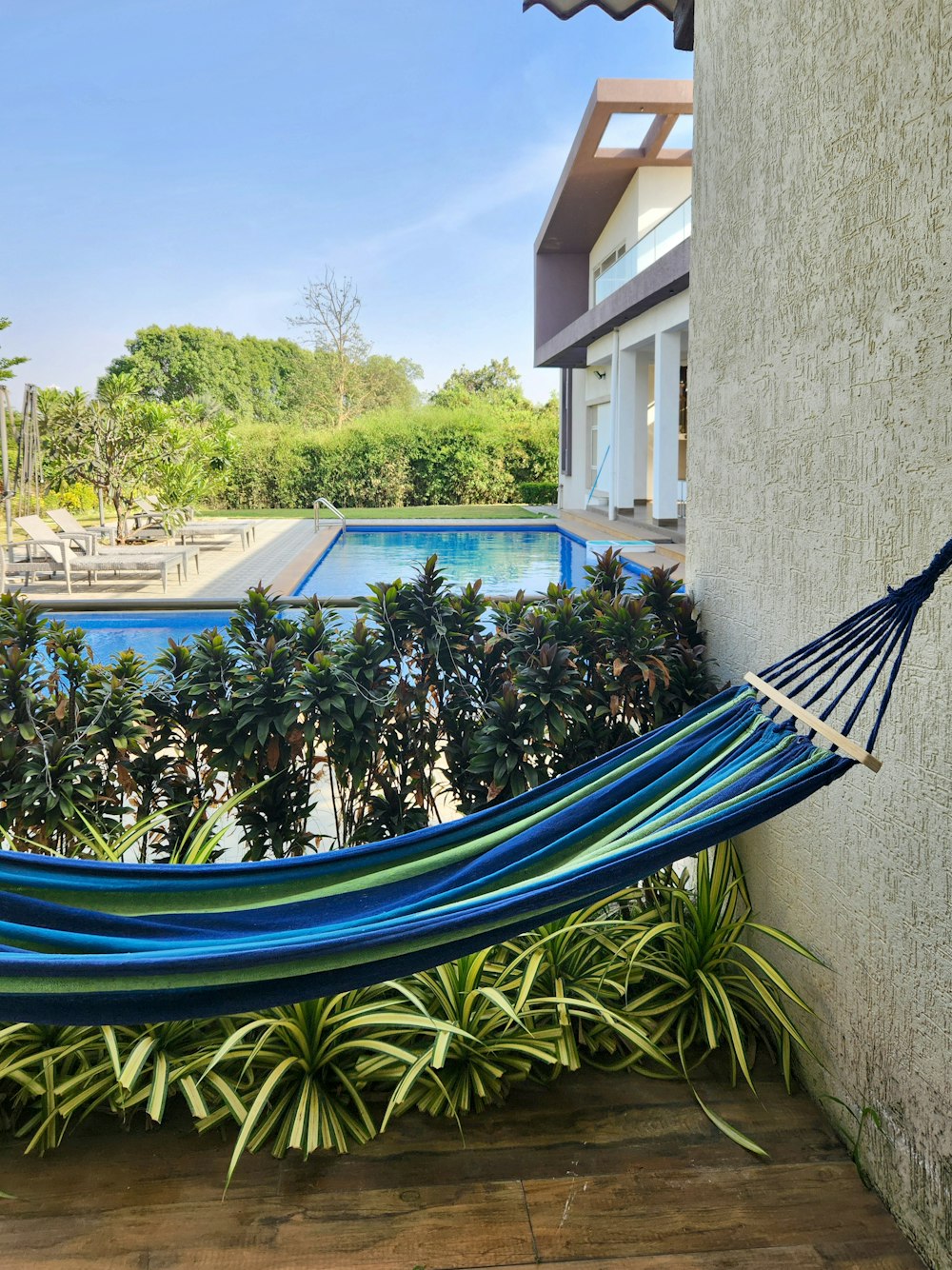 a blue hammock hanging from the side of a building