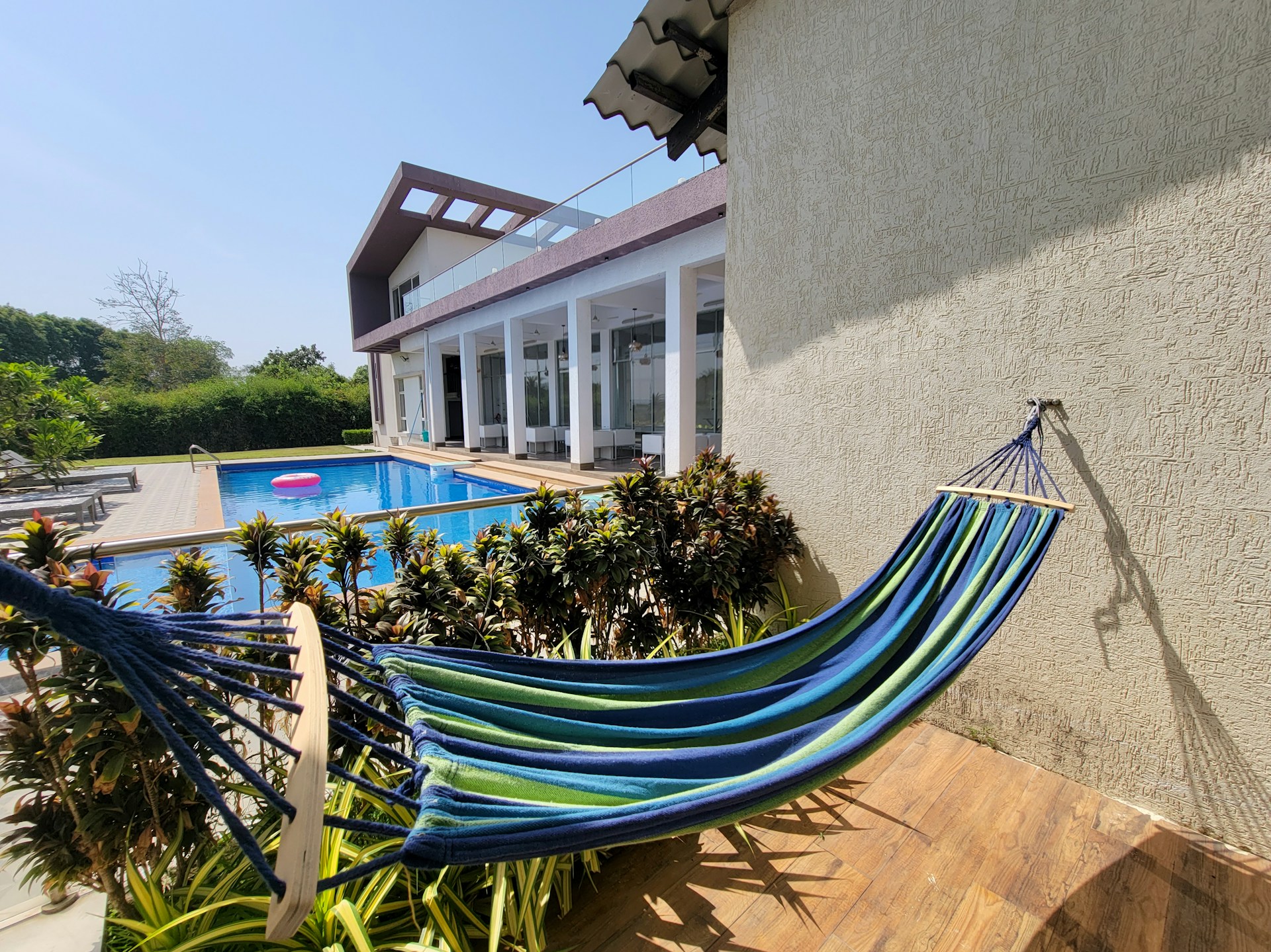 a blue hammock sitting in front of a house