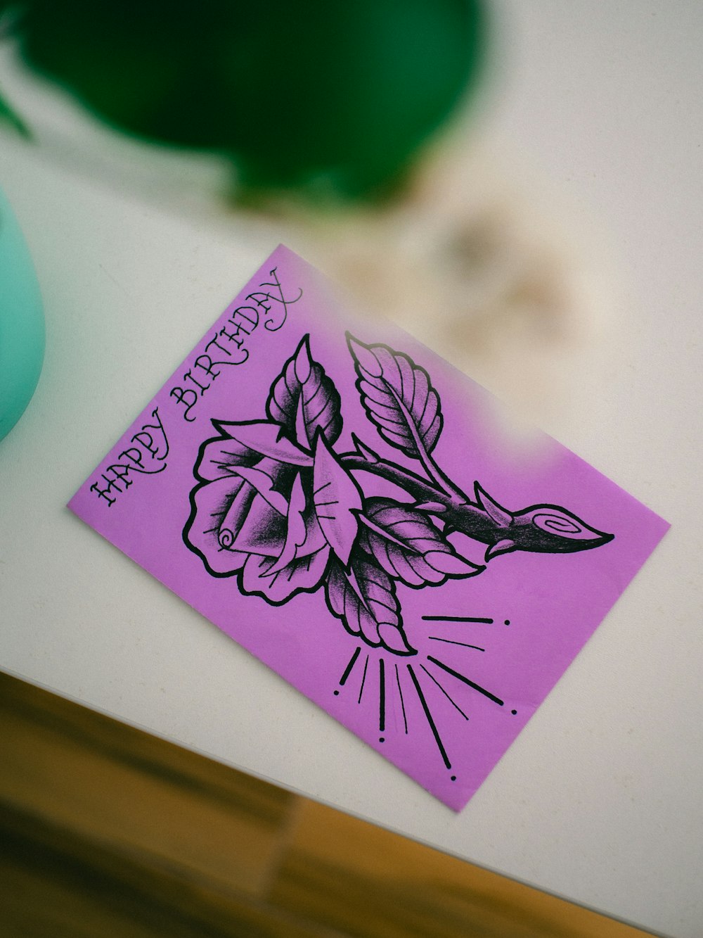a card with a drawing of a rose on it