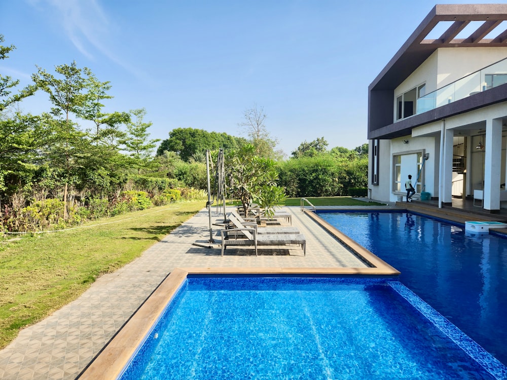 a large swimming pool in front of a house