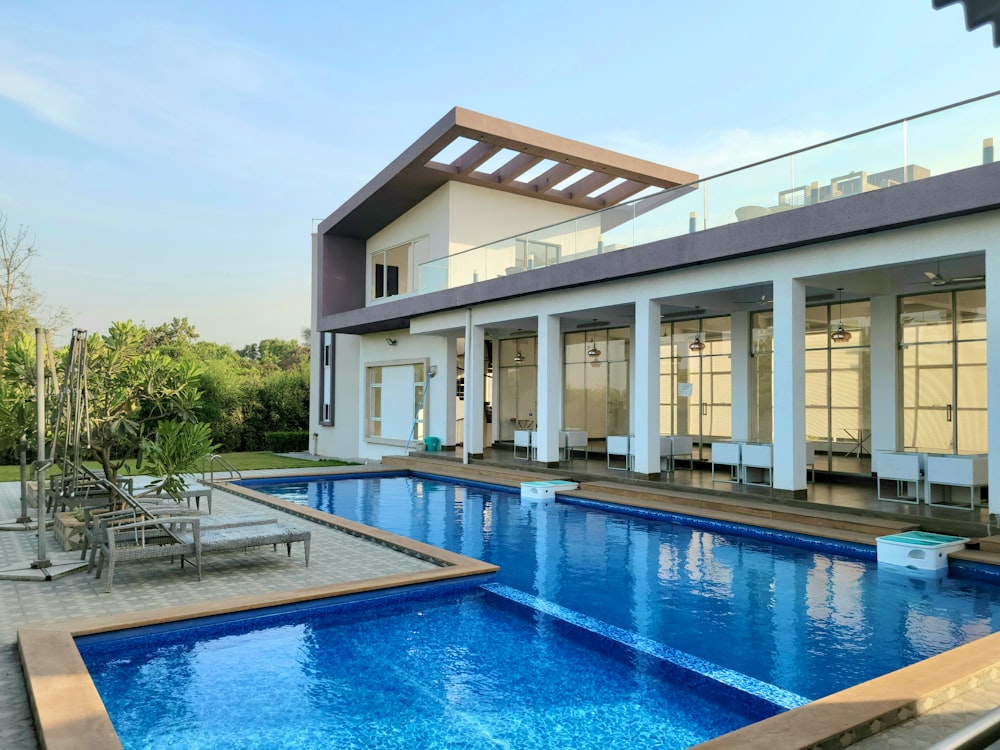 a house with a swimming pool in front of it