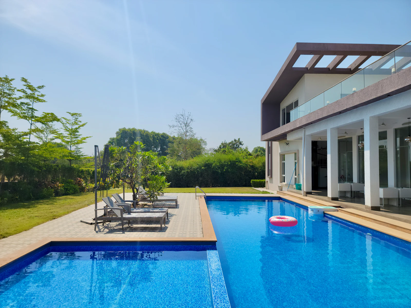 Inviting beach resort swimming pool at golden hour in Daman