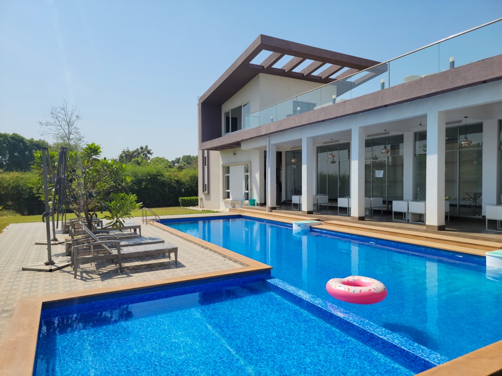 a large swimming pool with a lounge chair next to it