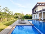 a large swimming pool next to a house