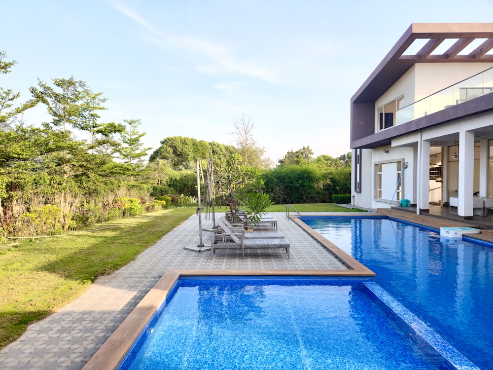 a large swimming pool next to a house