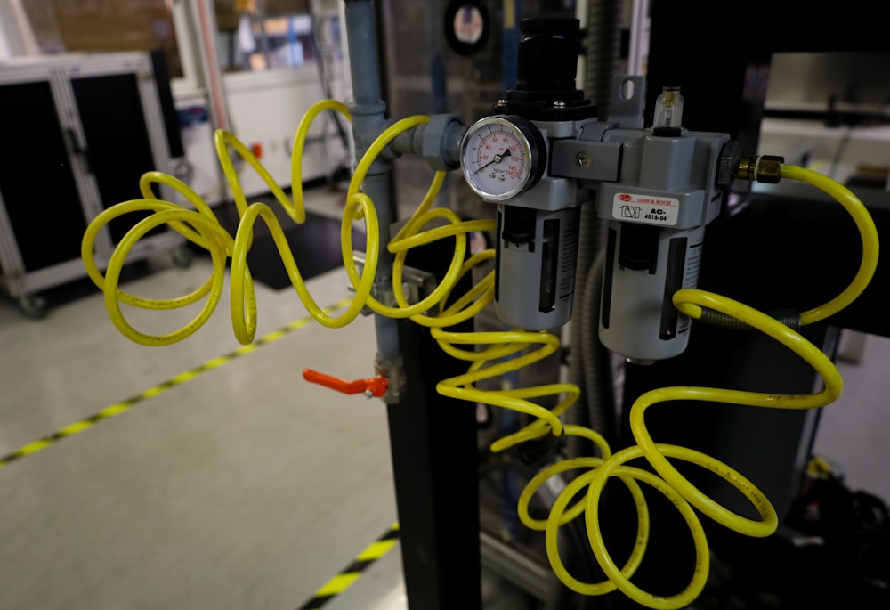 a machine with yellow hoses attached to it