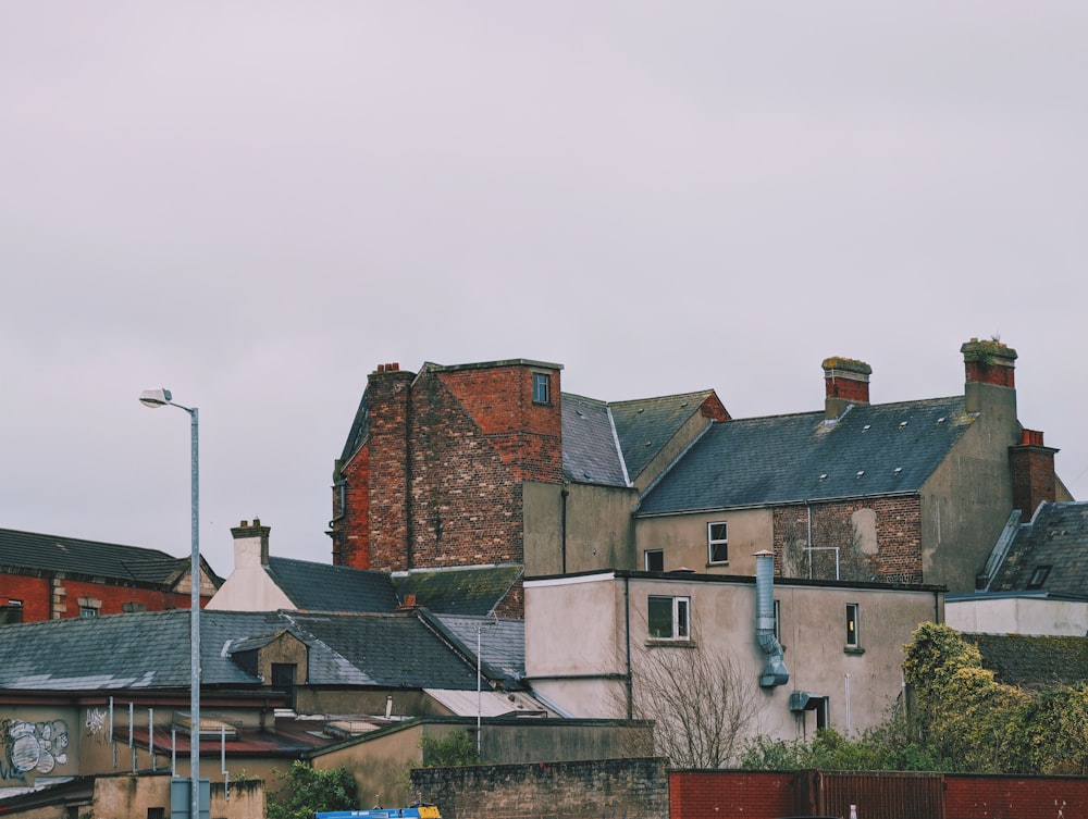 a row of brick buildings with a clock tower in the background